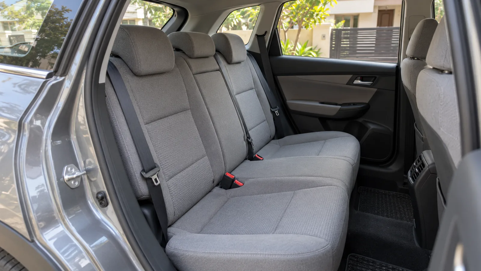 AI-generated illustration of a generic car rear bench and seat belts, not an actual Autoliv product photograph or model-specific safety claim
