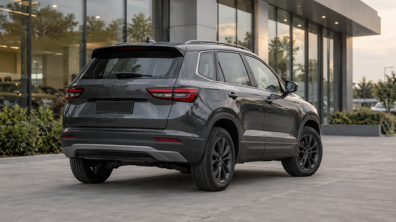 Illustrative generic charcoal SUV at a modern unbranded vehicle handover forecourt