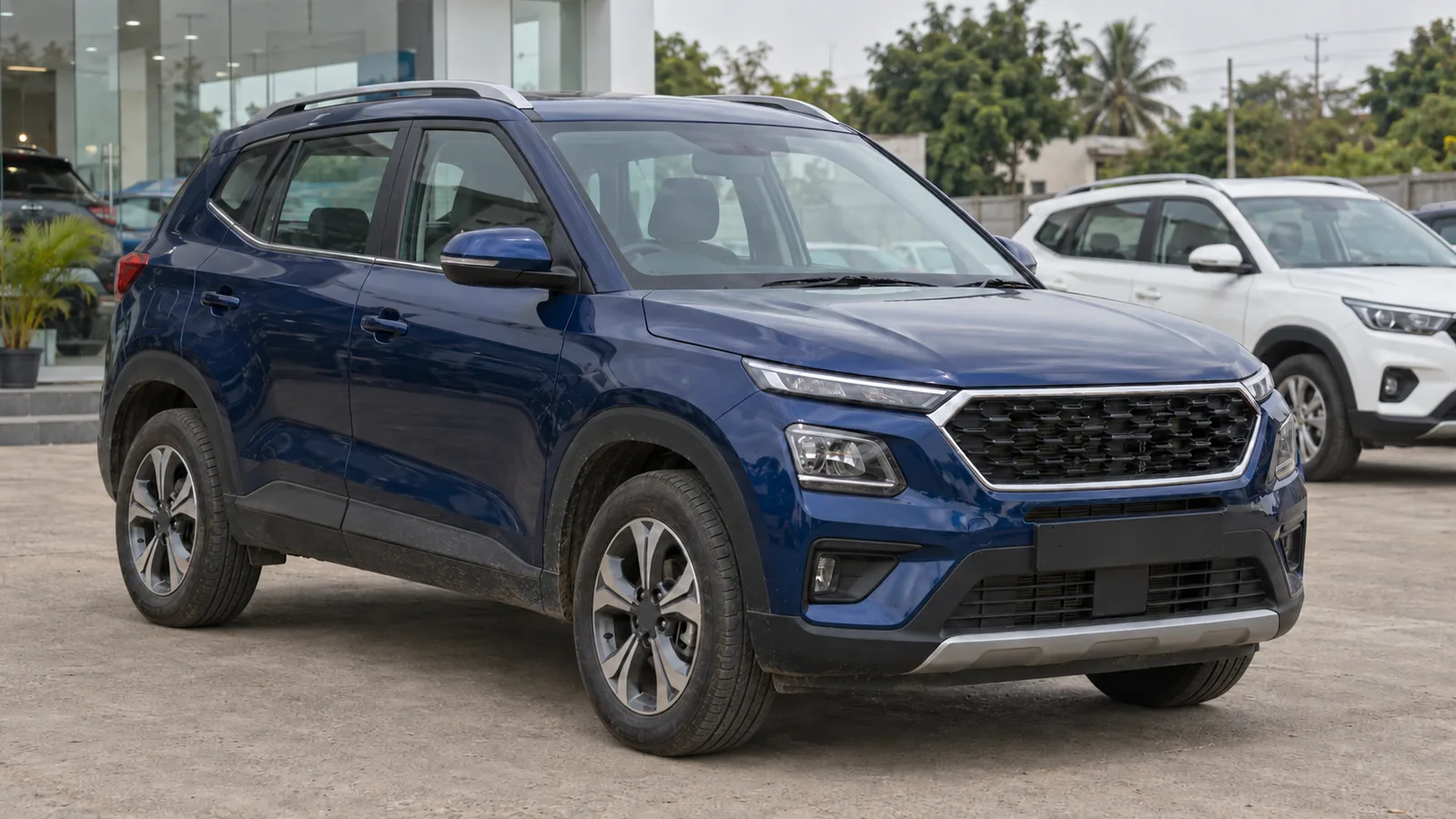 Generic blue compact SUV with a white crossover behind it at an Indian dealer forecourt, illustrative scene