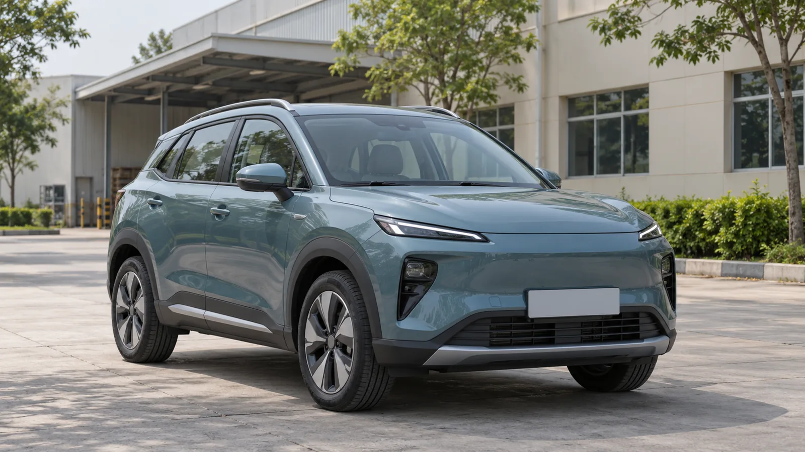 Generic unbranded teal electric crossover outside a southern Indian industrial building, illustrative scene