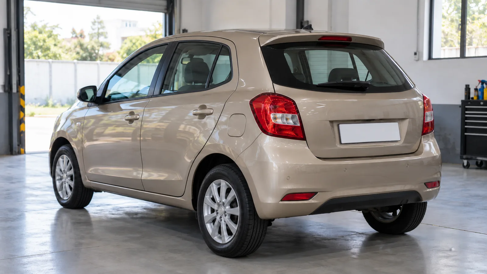 Generic unbranded champagne-beige hatchback in a tidy Indian used-car inspection bay, illustrative scene