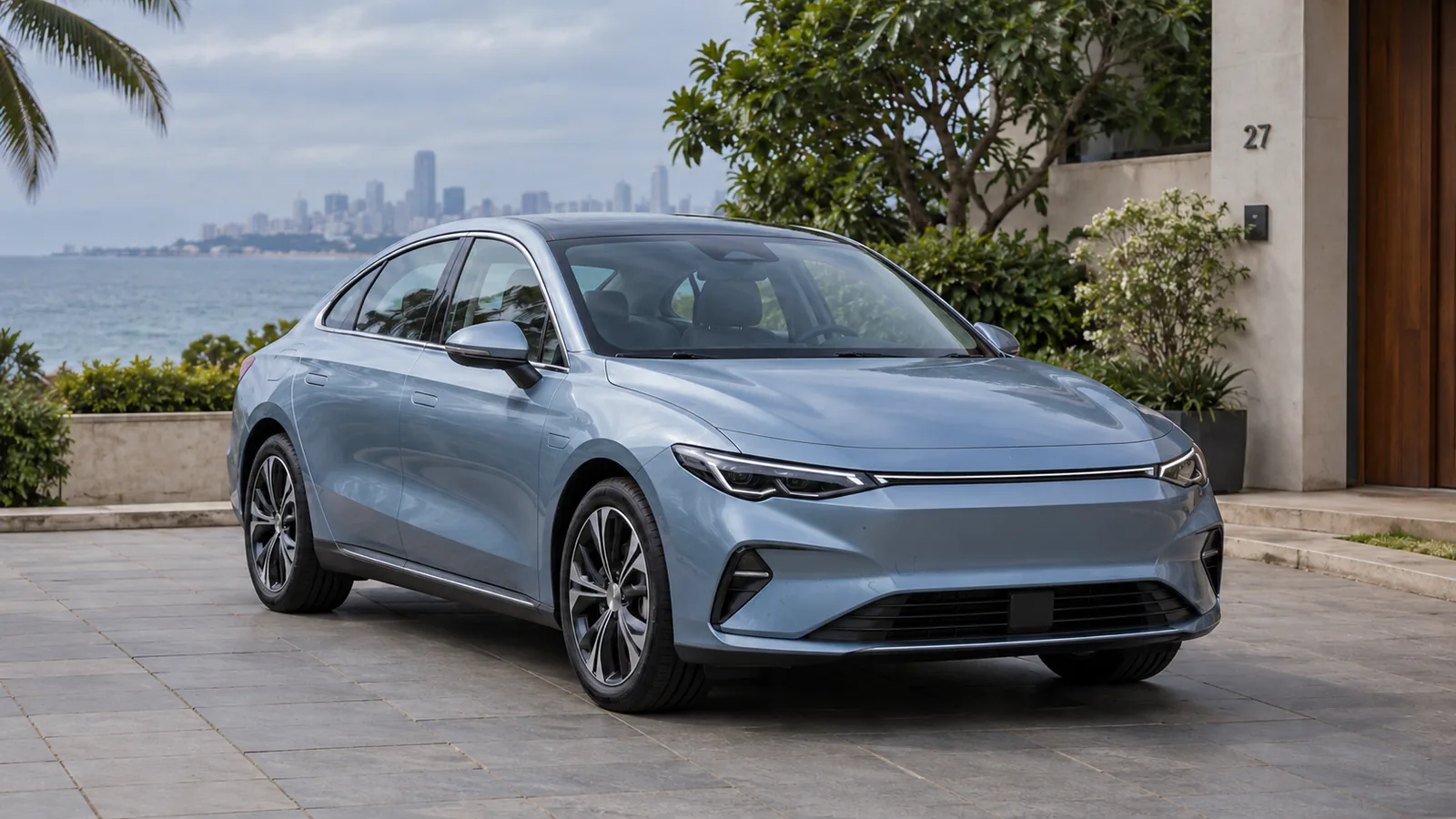 Illustrative unbranded light-blue electric sedan parked beside a Mumbai waterfront residence