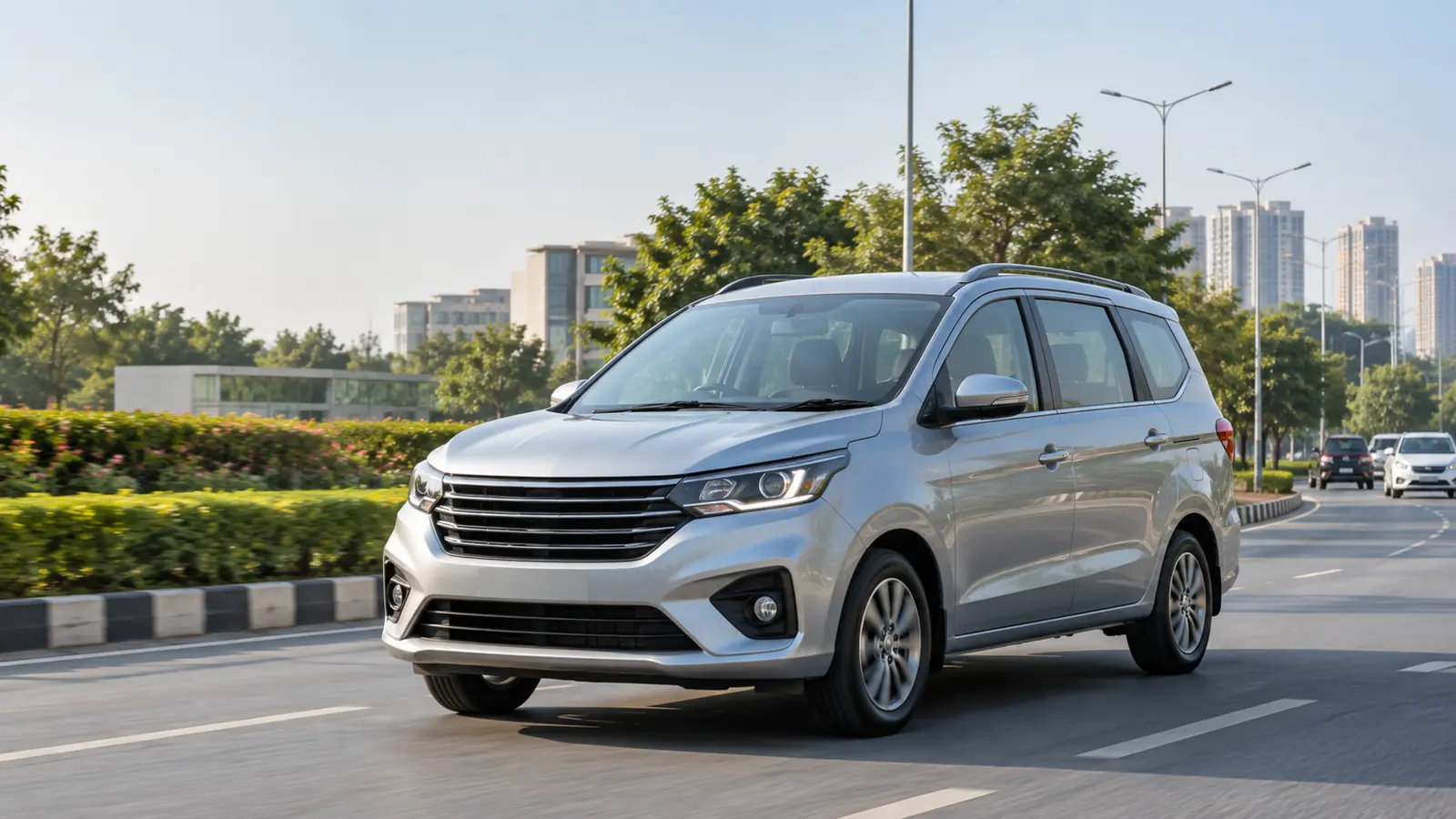 Illustrative silver compact seven-seat family MPV driving on an Indian city road