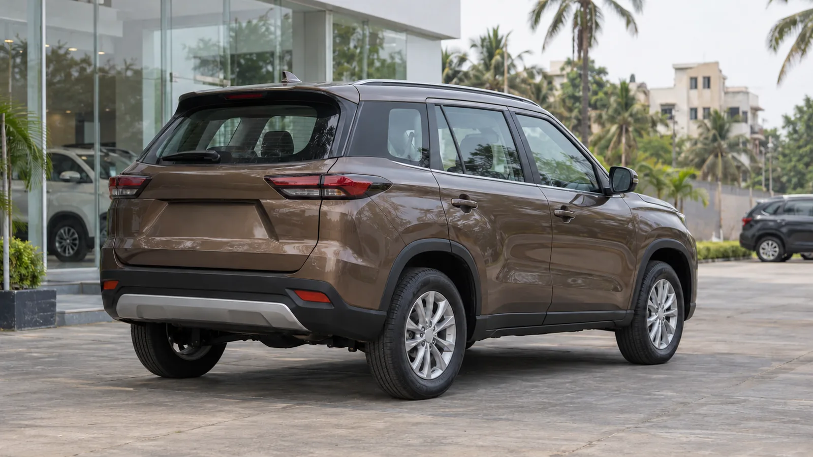 Illustrative unbranded bronze SUV outside a car dealership in Karnataka
