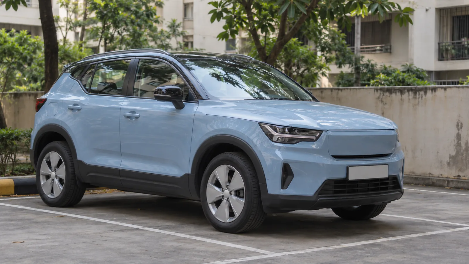 Illustrative unbranded pale-blue compact electric SUV in a Mumbai residential parking bay